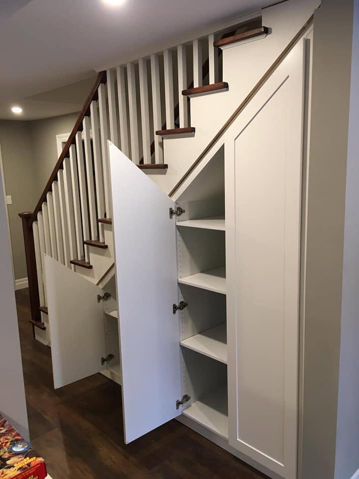 Under-stair cabinetry with open storage by LG Woodworking