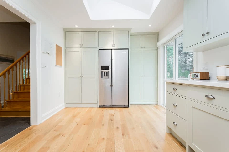 Pale kitchen refrigerator wall by LG Woodworking