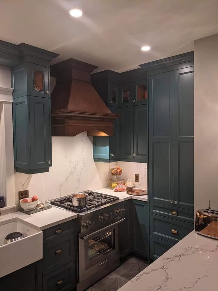 Dark cabinetry with timber range hood by LG Woodworking