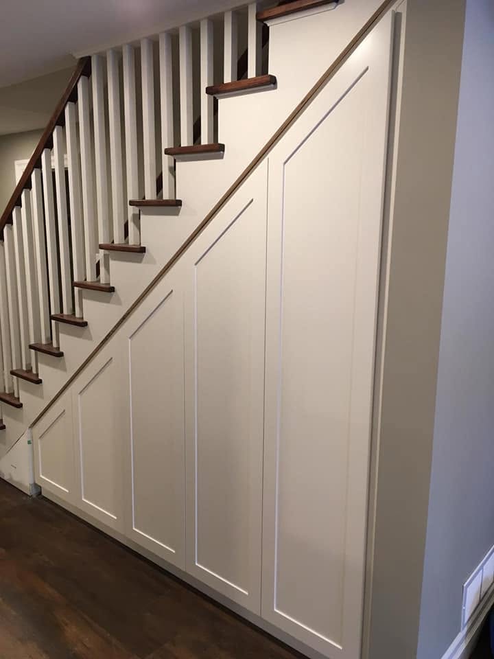 Under-stair cabinetry with closed doors by LG Woodworking